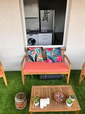 a bench with pillows and a table in a room at CASA NINA FURIANI CORSE Appartement en résidence in Paterno