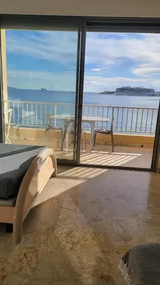 a bedroom with a bed and a view of the ocean at La plage à vos pieds, magnifique vue sur Ajaccio, pour 2 personnes in Ajaccio