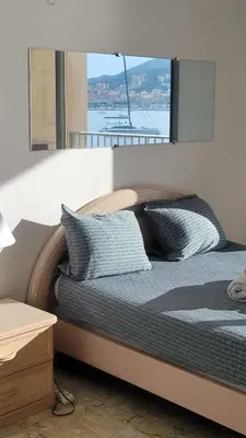 a bed with two pillows on it in a room at La plage à vos pieds, magnifique vue sur Ajaccio, pour 2 personnes in Ajaccio