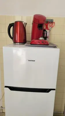 a red appliance sitting on top of a white refrigerator at La plage à vos pieds, magnifique vue sur Ajaccio, pour 2 personnes in Ajaccio