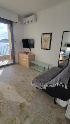 a bedroom with a bed and a view of the ocean at La plage à vos pieds, magnifique vue sur Ajaccio, pour 2 personnes in Ajaccio