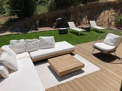 a white couch and two chairs on a deck at Maison avec piscine, à proximité des plages in Porto-Vecchio