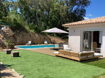 a villa with a swimming pool and a house at Maison avec piscine, à proximité des plages in Porto-Vecchio