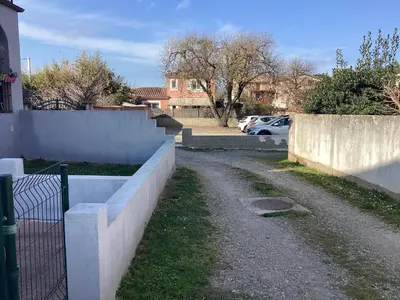 a fence next to a road in a yard at Appartement Bavella in Santa-Lucia-di-Moriani