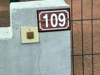 a sign on a wall with the number on it at Appartement Bavella in Santa-Lucia-di-Moriani