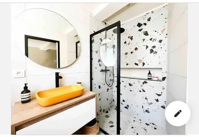 a bedroom with a white bed with two towels on it at Charmant appartement Olmeto in Olmeto