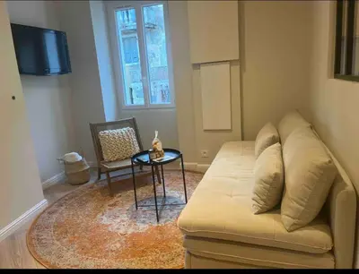an open door to a balcony with a view of a building at Charmant appartement Olmeto in Olmeto
