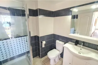 a bathroom with a toilet and a sink and a shower at Apartment with balcony and 360 sea view in Villanova