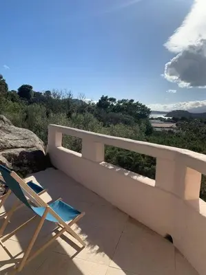 a couple of chairs sitting on a patio at Sea view villa - Cala Rossa private park in Lecci
