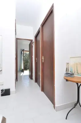 a hallway with doors and a table and a desk at Sea view villa - Cala Rossa private park in Lecci