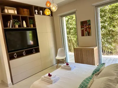 a bedroom with a tv and a bed with towels at Giulia, villa exceptionnelle, vue mer et Ajaccio in Porticcio