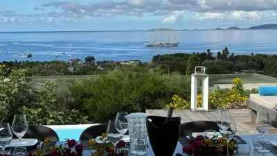 a table with wine glasses and a view of the ocean at Giulia, villa exceptionnelle, vue mer et Ajaccio in Porticcio