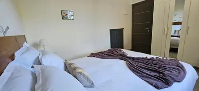 a bed with a blanket on it in a bedroom at T3 Paradisiaque sur la plage, les pieds dans l'eau in Olmeto