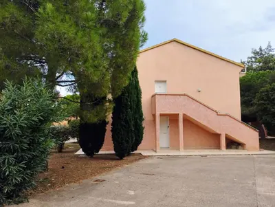a house with two large trees in front of it at Charmant appartement climatisé proche mer in Linguizzetta