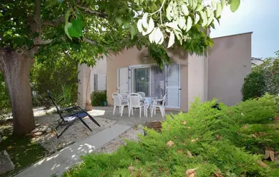 a patio with a table and chairs in front of a house at Beautiful Home In Cervione With Wifi in Cervione