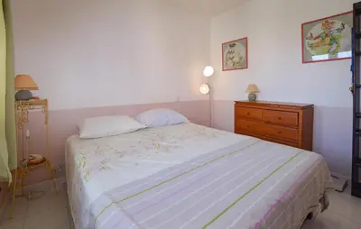 a bedroom with a large bed and a dresser at Beautiful Home In Cervione With Wifi in Cervione