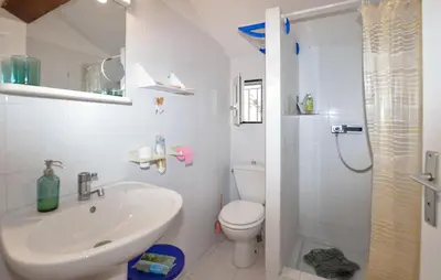 a white bathroom with a sink and a toilet at Beautiful Home In Cervione With Wifi in Cervione