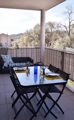 a table and two chairs on a patio at Studio Terrasse entre ville et port in Porto-Vecchio