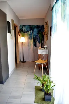 a living room with a table and a chair at Studio Terrasse entre ville et port in Porto-Vecchio
