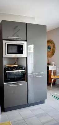 a kitchen with a stainless steel refrigerator and microwave at Studio Terrasse entre ville et port in Porto-Vecchio