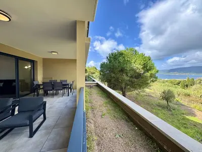 a balcony with chairs and a view of the ocean at T2 moderne avec vue mer et proche centre-ville in Propriano