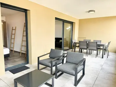 a waiting room with chairs and tables in a building at T2 moderne avec vue mer et proche centre-ville in Propriano