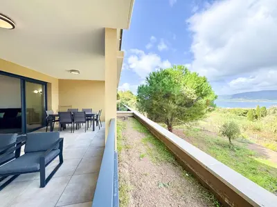 a balcony with chairs and a view of the ocean at T2 moderne avec vue mer et proche centre-ville in Propriano