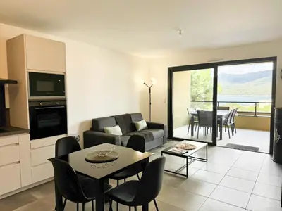 a living room with a couch and a table at T2 moderne avec vue mer et proche centre-ville in Propriano