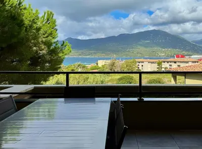 a balcony with a view of the ocean and mountains at T2 moderne avec vue mer et proche centre-ville in Propriano