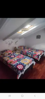 a room with two beds with flowers on them at APT 2 chambres vue exceptionnelle in Tiuccia