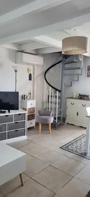 a living room with white furniture and a staircase at APT 2 chambres vue exceptionnelle in Tiuccia