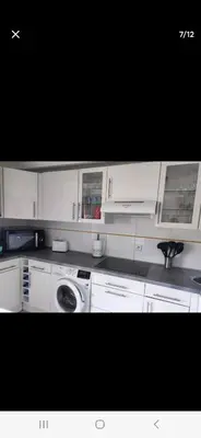 a kitchen with white cabinets and a washing machine at APT 2 chambres vue exceptionnelle in Tiuccia