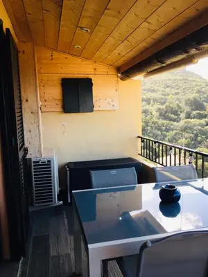 a balcony with a table and chairs and a view at APT 2 chambres vue exceptionnelle in Tiuccia