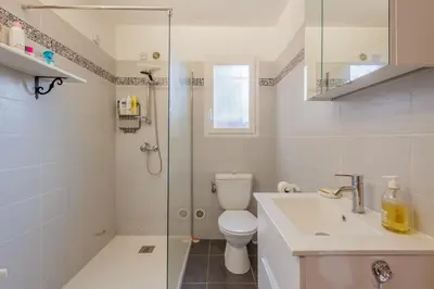a bathroom with a shower and a toilet and a sink at Jaso - Maison à 5min de la plage in Cervione