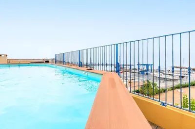 a swimming pool on a balcony with a view of the beach at La Marina - Appt climatisé pour 4 in Sari Solenzara
