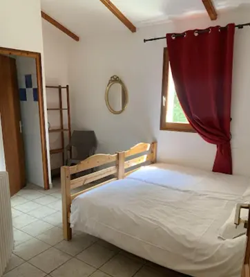 a bedroom with a bed with a red curtain at Gîte de randonneurs Bocca bè in Chisa