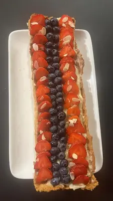 a sandwich with fruit on a white plate at Gîte de randonneurs Bocca bè in Chisa