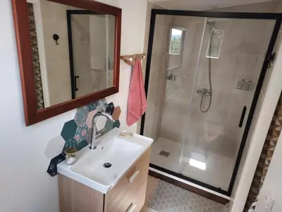 a bathroom with a sink and a shower at Suite indépendante avec vue in Sarrola-Carcopino