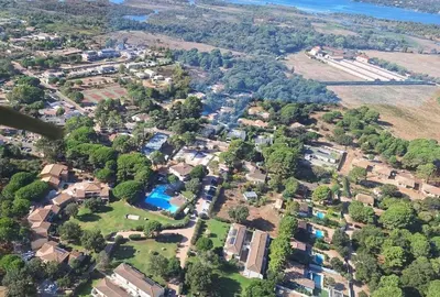 an aerial view of a neighborhood with houses and trees at Mini Villa T4 duplex dans résidence hôtelière Fiori di Cala Rossa superbement arborée rénovée en 2023 - chez Anne avec piscine chauffée in Lecci