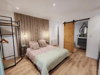 a bedroom with a bed and a wooden floor at Gîte casa di l'Apa in Venaco