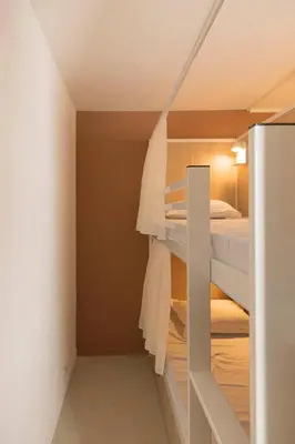 a room with two bunk beds in it at Corsica Hostel Porto Vecchio - partie chambre privée in Porto-Vecchio