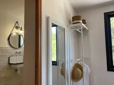 a bathroom with a shower and a sink and a mirror at Corsica Hostel Porto Vecchio - partie chambre privée in Porto-Vecchio