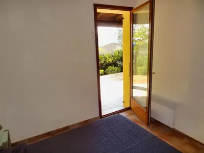 a room with a door leading to a balcony at U Sole Livante mini villa vue mer Santa Giulia in Porto-Vecchio
