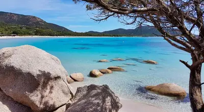 a view of a beach with rocks and blue water at U Sole Livante mini villa vue mer Santa Giulia in Porto-Vecchio