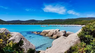a view of a beach with rocks in the water at U Sole Livante mini villa vue mer Santa Giulia in Porto-Vecchio