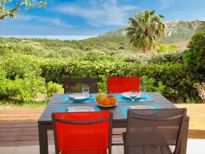 a dining table with a bowl of fruit on it at U Sole Livante mini villa vue mer Santa Giulia in Porto-Vecchio