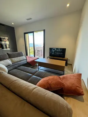 a living room with a couch and a table at T3 de standing à Piana in Piana