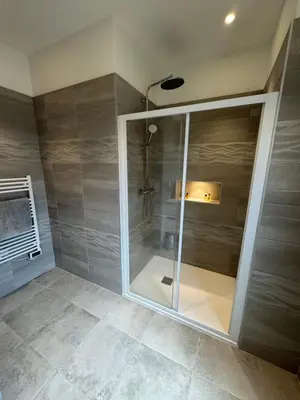 a shower with a glass door in a bathroom at T3 de standing à Piana in Piana