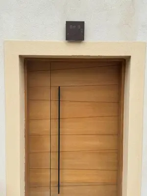 a wooden garage door with a sign above it at T3 de standing à Piana in Piana