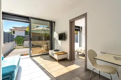 a living room with a view of a balcony at Paradisu - Apt climatisé de 32 m² in Porticcio